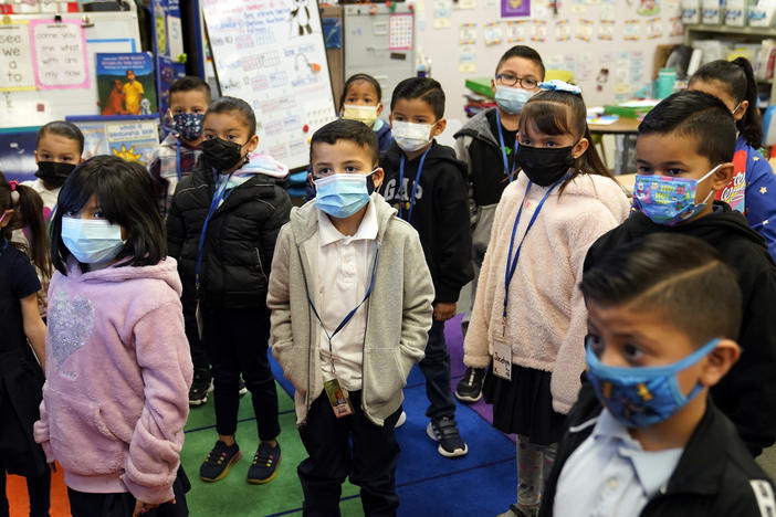Kindergarteners wear masks while listening to their teacher amid the COVID-19 pandemic at Washington Elementary School in Lynwood, Calif., on Jan. 12. Gov. Gavin Newsom delayed a closely watched decision on lifting California's school mask mandate on Feb. 14 even as other Democratic governors around the country dropped them.