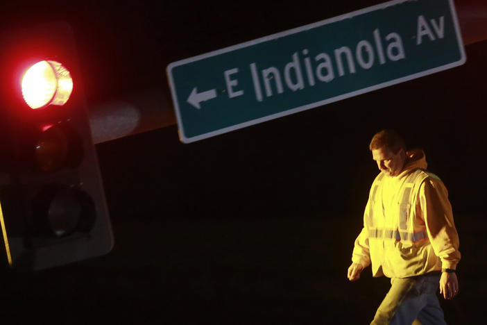 A utility worker tends to a downed stoplight on Highway 69 in Des Moines, Iowa, on Saturday, March 5, 2022, after a strong storm that hit parts of central Iowa.