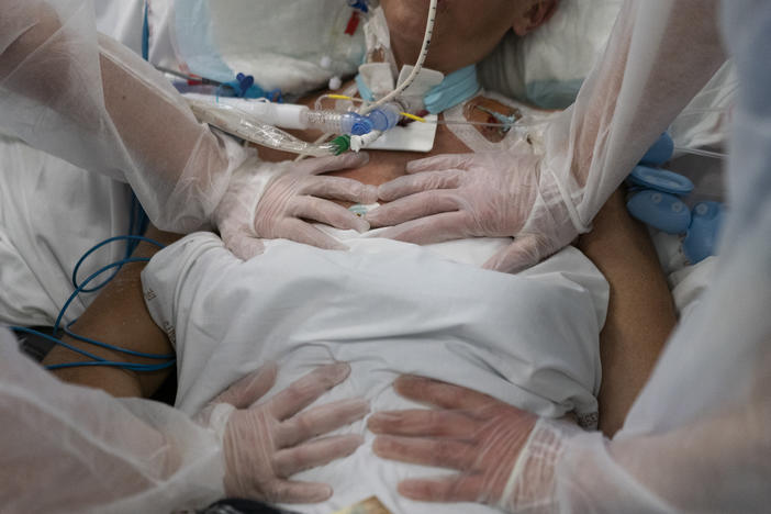 Nurses perform timed breathing exercises on a COVID-19 patient on a ventilator in the COVID-19 intensive care unit at the la Timone hospital in Marseille, southern France on Dec. 31, 2021.