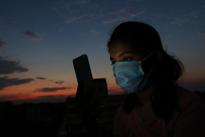 A teen girl with a smart phone in Kolkata, India, photographed in April 2020 during the government-imposed lockdown. Schools pivoted to virtual learning, which shut out many students — especially girls in low-income communities — without access to mobile devices.