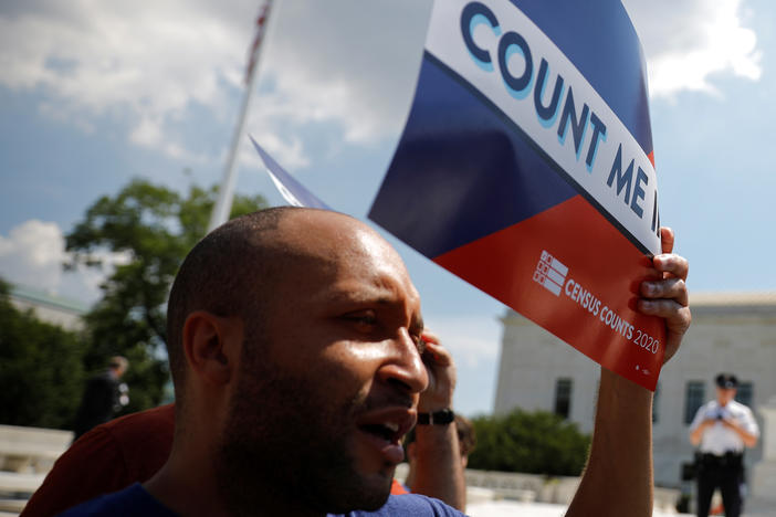 Demonstrators hold signs saying "Count Me In" outside the U.S. Supreme Court in Washington, D.C., in 2019, when the court blocked former President Donald Trump's administration from adding a citizenship question to 2020 census forms.