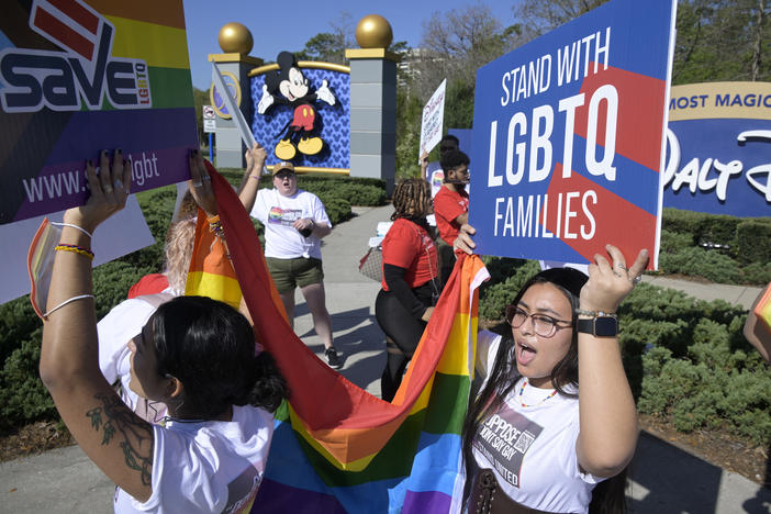 LGBTQ advocates march at a rally at Walt Disney World in Orlando, Fla., to urge the company to publicly oppose what they call the "Don't Say Gay" that aims to limit instruction of gender identity and sexual orientation in schools.