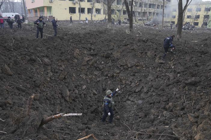 A massive crater sits outside of a maternity hospital that local officials say was severely damaged on Wednesday by a Russian attack in the besieged port city of Mariupol, Ukraine.