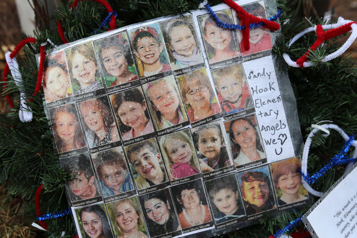 Photos of Sandy Hook Elementary School massacre victims sits at a small memorial near the school on Jan. 14, 2013 in Newtown, Conn.
