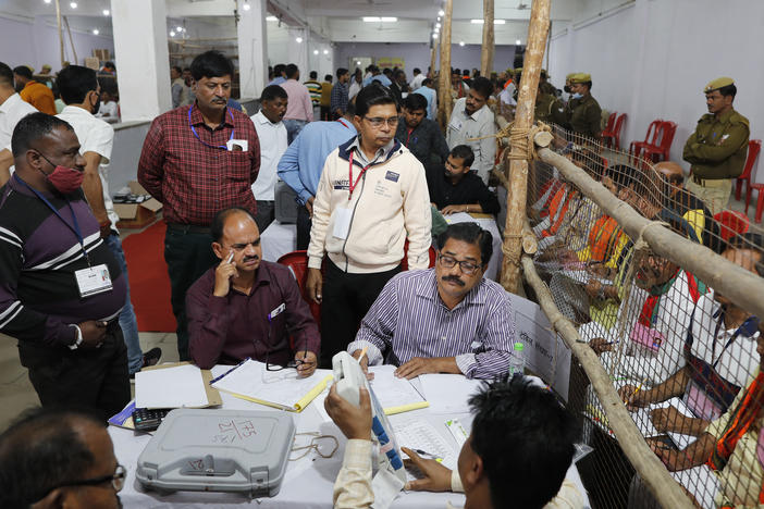 Election officials count votes after Uttar Pradesh state elections in Lucknow, India on Thursday.