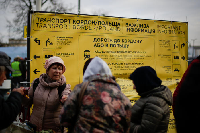As people pour off the trains arriving in Lviv, signs offer guidance on transportation, shelter and other aid.