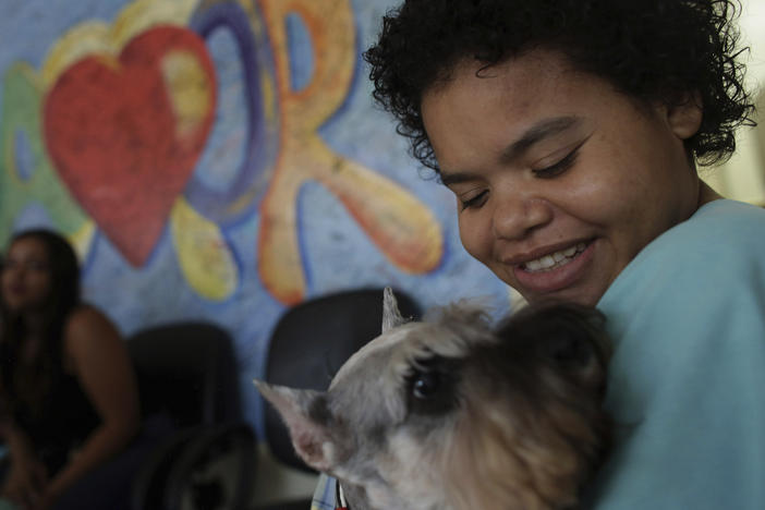 Jaqueline Castro plays with a Schnauzer named Paola at the Support Hospital of Brasilia, Brazil, on Nov. 24, 2016, as part of program set up to help patients with chronic diseases or recovering from trauma.