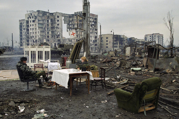 Russian soldiers rest in Chechnya's capital, Grozny, in February 2000. Russia waged two wars against Chechnya from 1994 to 2000. In both wars, Russia heavily bombed Chechnya, flattening Grozny and causing tens of thousands of civilian deaths.