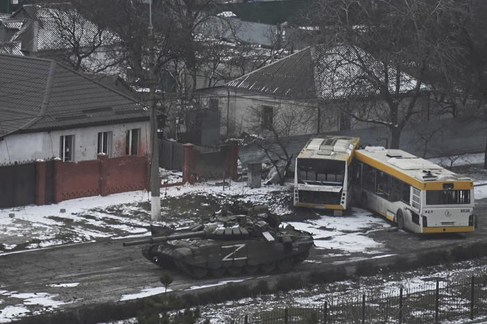A Russian army tank moves through a street on the outskirts of Mariupol, Ukraine, on Friday, March 11, 2022.