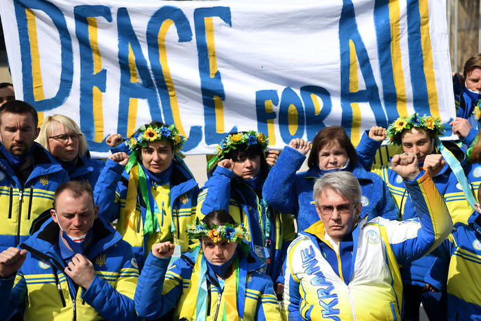 President of Ukraine's Paralympic Committee Valerii Sushkevych and members of Team Ukraine hold a banner up reading "Peace for All" in the Athletes Village during day six of the Beijing 2022 Winter Paralympics.