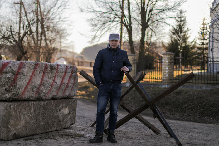 Oleh Pokrovsky helps man a small checkpoint on a bumpy road leading to his village. "The privilege that we have of sitting here at this checkpoint is thanks directly to those who are enlisted in the military and are defending Ukraine's borders," he says. "If it weren't for them, then this would be under Russian occupation right now."