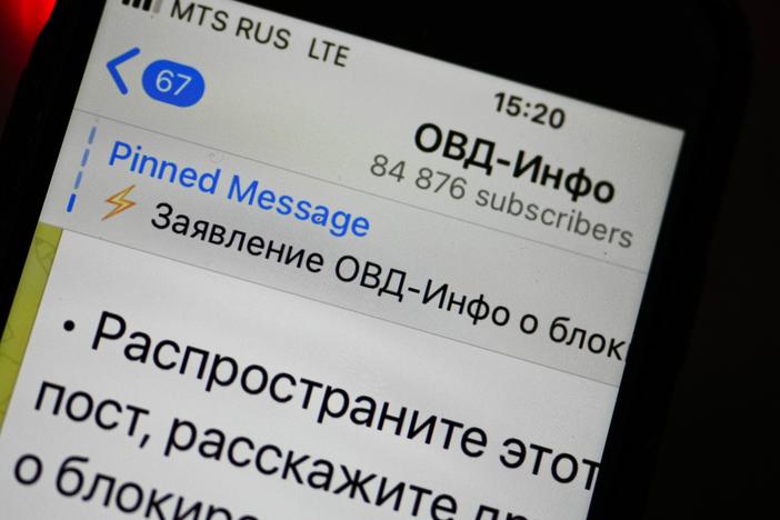 An iPhone screen shows a Telegram account of OVD-Info, prominent legal aid group in Russia that tracks political arrests in Moscow.