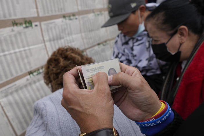People check a voter list to confirm where they should cast their ballots during legislative elections in Bogota, Colombia, on Sunday.