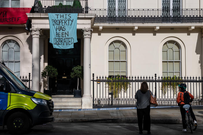 Protesters occupy a building reportedly belonging to Russian oligarch Oleg Deripaska on Monday in London.
