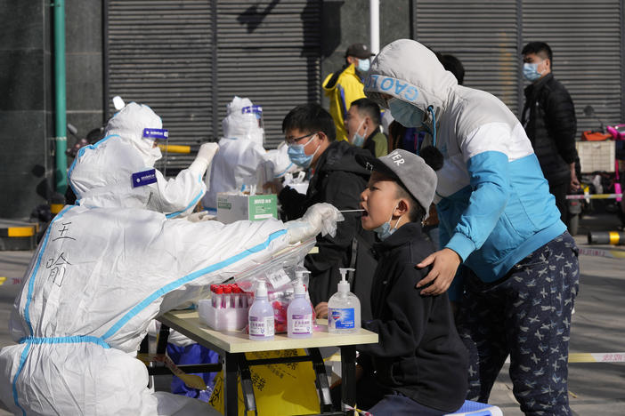 Residents get tested for the coronavirus at an outdoor facility on Monday in Beijing.