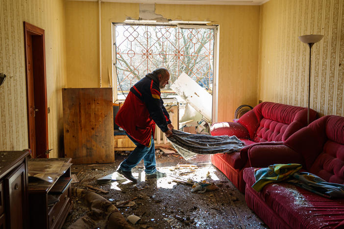 Local residents recover, pack and clean out their homes in a damaged residential building in the Vynogradir district of Kyiv on Tuesday. Authorities said the damage was caused by a Russian bombardment.