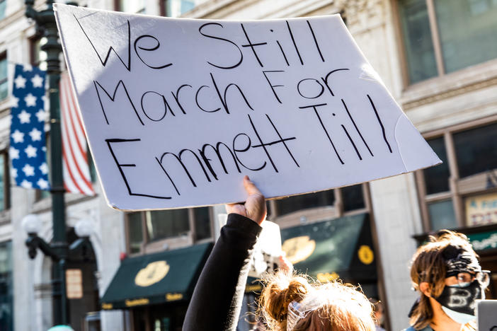 A woman holds a sign in honor of Emmett Till during a protest on June 13, 2020, in Chicago. Protests erupted across the U.S. after George Floyd was killed while in police custody in Minneapolis on May 25, 2020.