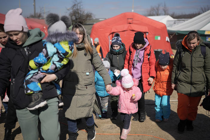Refugees fleeing Ukraine receive food from the International Red Cross and other organizations at the Vysne Nemecke border crossing in Slovakia on Sunday.