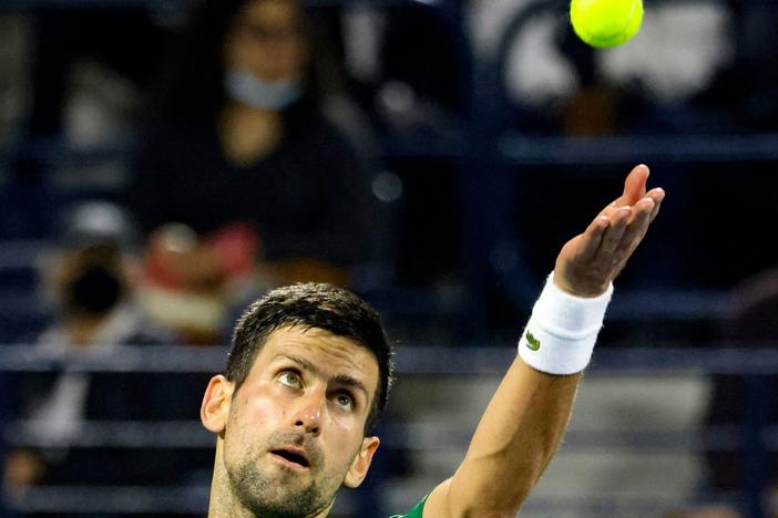 Novak Djokovic of Serbia plays against Russian Karen Khachanov, during the ATP Dubai Duty Free Tennis Championship on Feb. 23. Thanks to loosening COVID-19 restrictions in France, Djokovic is set to compete in May at the French Open.