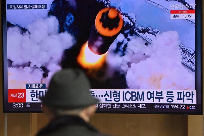 People watch a television screen showing a news broadcast with file footage of a North Korean missile test, at a railway station in Seoul on Wednesday, after North Korea fired an "unidentified projectile."