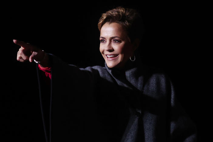 Republican candidate for Arizona governor Kari Lake points to the crowd at a rally for former President Donald Trump on Jan. 15 in Florence, Ariz. Lake's introductory campaign ad included baseless claims of a rigged 2020 election.