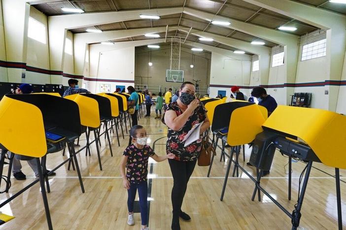 Voters cast their ballots Election Day in 2020 in East Los Angeles. Smartmatic says it's the only county they were operating in for the presidential election, but Fox News mentioned the company 137 times in a month afterward as President Trump and his allies pressed baseless claims of a rigged election.