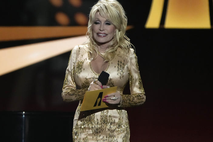 The Rock & Roll Hall of Fame has declined Dolly Parton's request to pull her nomination from this year's nominee list. Here, Parton presents an award at the Academy of Country Music Awards on March 7.