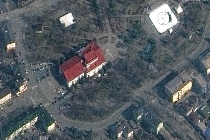 A satellite of the Mariupol theater from Monday, before it was bombed. The word "Children" is written in white on the pavement.