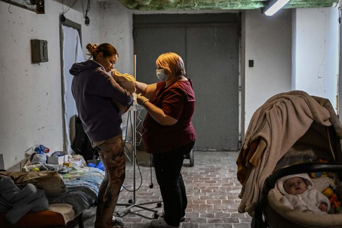 A nurse checks a baby in a hospital basement being used as a bomb shelter in Kyiv, Ukraine. More than 300 health facilities lie within conflict lines or areas that Russia claims to control, according to the World Health Organization.