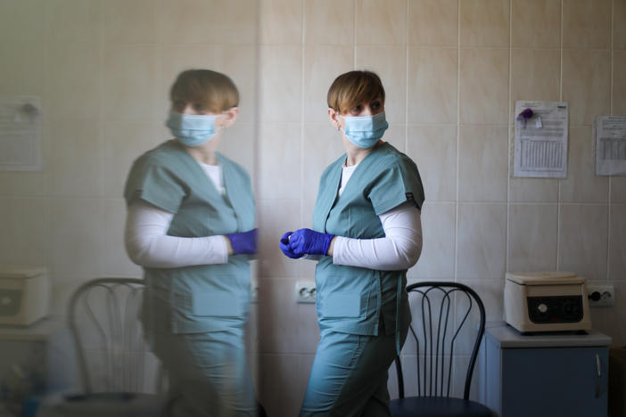 A nurse administers a shot to a patient.