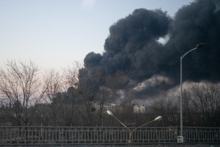 Smoke billows over a street near the airport in Lviv, Ukraine.