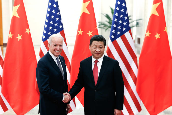 Chinese President Xi Jinping shakes hands with then-U.S Vice President Joe Biden inside the Great Hall of the People on December 4, 2013, in Beijing.
