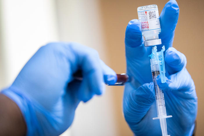 A Moderna COVID-19 vaccine is prepared during a pop-up vaccine clinic at Cristo Rey Church in East Austin last summer.