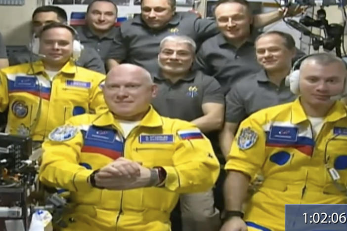 Russian cosmonauts (from left) Sergey Korsakov, Oleg Artemyev and Denis Matveev wear yellow at the International Space Station.