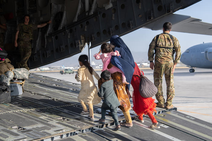 A family enters a U.S. Air Force plane in Kabul, Afghanistan, on Aug. 24, 2021. The evacuation was part of a U.S. effort to relocate Afghans to safety in the wake of the Taliban siege. But many families were separated in the process — and reuniting them has proven to be a challenge.