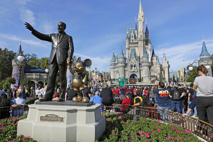 A statue of Walt Disney and Micky Mouse stand near the Cinderella Castle at the Magic Kingdom at Walt Disney World in Lake Buena Vista, Fla. on Jan. 9, 2019.