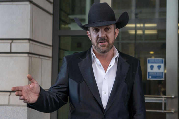 Couy Griffin, a commissioner in Otero County, N.M., speaks to journalists as he leaves the federal court in Washington, D.C., on March 21, 2022.