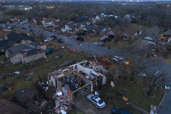 Debris litters the ground surrounding homes, damaged by a tornado in Round Rock, Texas, on Monday.