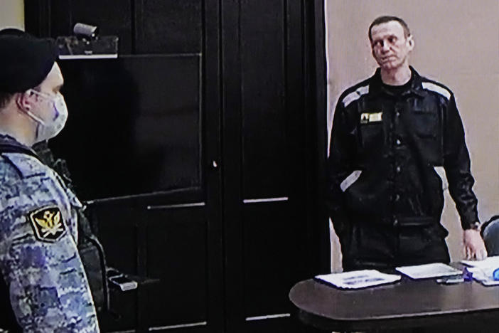 Russian opposition leader Alexei Navalny (right) is seen via a video link provided by the Russian Federal Penitentiary Service. Access to his trial has been limited.
