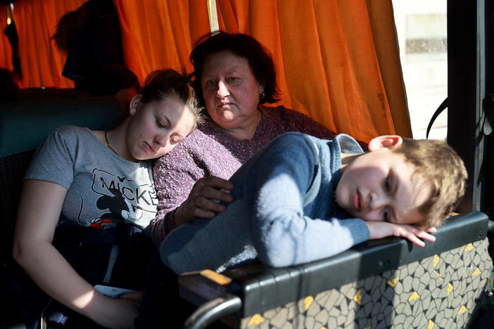 Sywasz Elizabeth, Samarska Ludmyla and Pylypenko Arsenij wait on a bus after arriving safely on a train in Lviv, Ukraine, from the Ukrainian city of Mariupol, which has been under heavy Russian military attack, on Tuesday. Trains carried hundreds of evacuees from the besieged city, where thousands of residents remain trapped amid Russian bombardment.