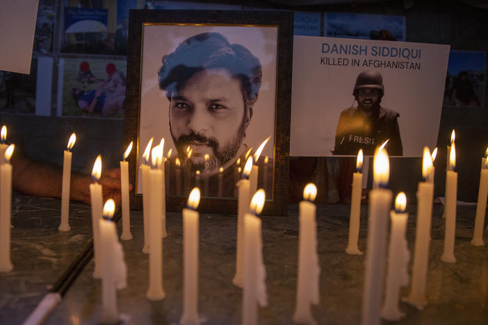 In this July 17, 2021, file photo, candles lit by journalists in New Delhi pay tribute to photojournalist Danish Siddiqui, who was killed in Afghanistan covering clashes between the Taliban and Afghan security forces.