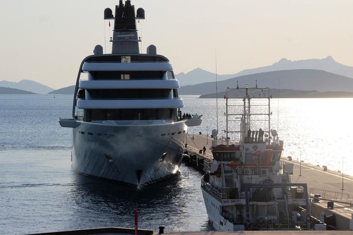 A yacht reportedly belonging to Russian oligarch Roman Abramovich is docked at an Aegean coastal resort in Bodrum, Turkey, on Monday. A group of young Ukrainian sailors had protested its arrival from a small boat.