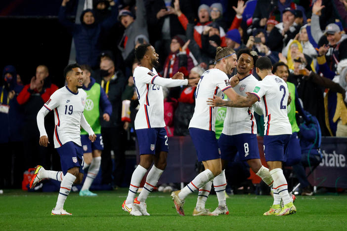 Weston McKennie (No. 8) of the United States is congratulated by his teammates after scoring a goal during the FIFA World Cup 2022 Qualifier match against Mexico at TQL Stadium on Nov. 12, 2021, in Cincinnati. The U.S. defeated Mexico 2-0.