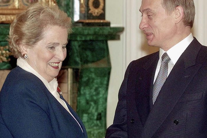 U.S. Secretary of State Madeleine Albright smiles as she shakes hands with Russian acting President Vladimir Putin, right, in Moscow's Kremlin, in 2000. Albright has died of cancer, her family said Wednesday.