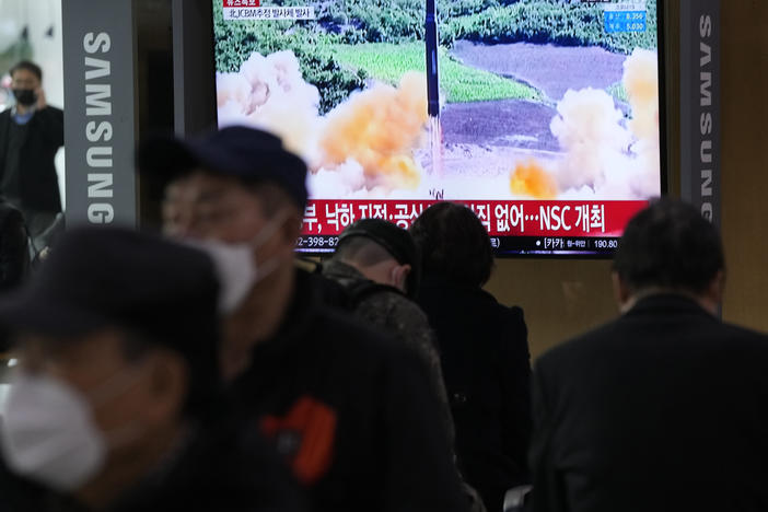 People watch a TV showing a file image of North Korea's missile launch during a news program at the Seoul Railway Station in Seoul, South Korea, on Thursday.