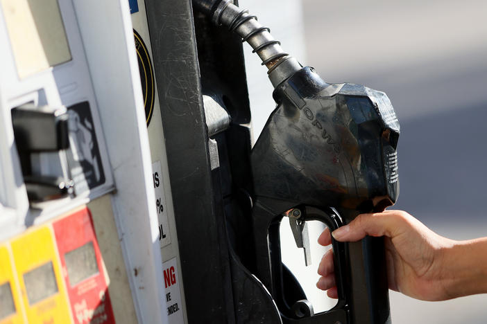 MIAMI, FLORIDA - NOVEMBER 22: Gabriela Chirinos places the handle back on the pump after filling her vehicle with gas at a Shell station on November 22, 2021 in Miami, Florida. Florida Governor Ron DeSantis announced he would ask state lawmakers to temporarily "zero out" state gas taxes next year.