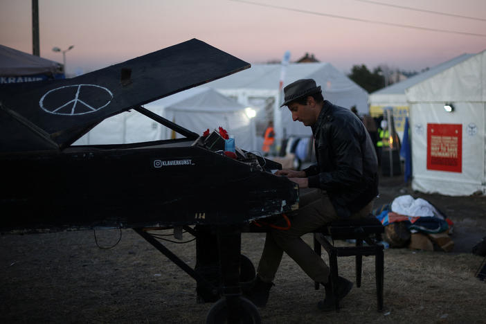 Davide Martello, an Italian man living in Germany, plays the piano for people who have fled Ukraine at the border crossing in Medyka, Poland.