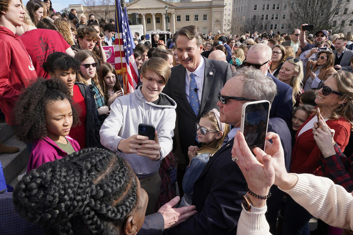 Last month, Virginia Gov. Glenn Youngkin posed with school children and parents after signing a bill that bans mask mandates in public schools in Virginia.