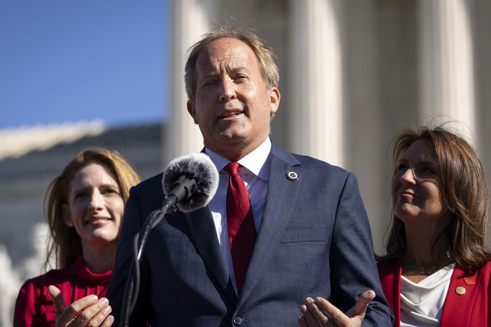 Texas Attorney General Ken Paxton says a weeklong celebration of Pride events in Austin schools this week violates state law. Here, he speaks outside the U.S. Supreme Court on Nov. 1.