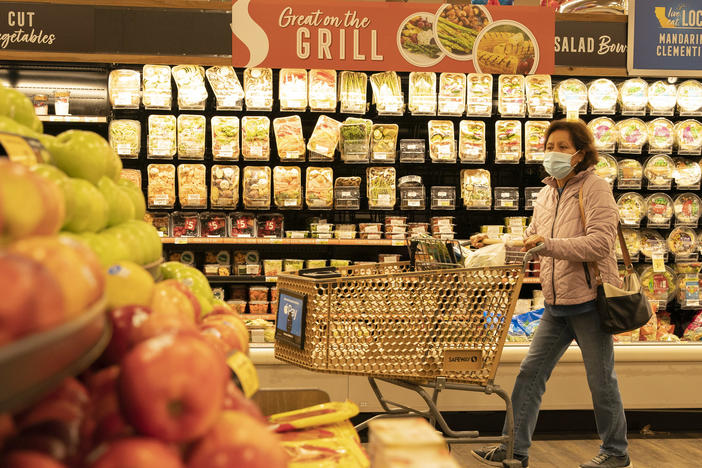 A woman shops for fruits at a supermarket on March 10, 2022 in San Mateo County, California.